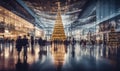 A shopping mall decorated for christmas with a large illuminated Christmas tree and busy shoppers Royalty Free Stock Photo