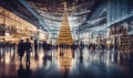 A shopping mall decorated for christmas with a large illuminated Christmas tree and busy shoppers