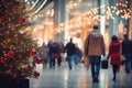 Shopping mall decorated for Christmas time. Crowd of people looking for presents and preparing for the holidays Royalty Free Stock Photo