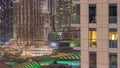 Shopping mall exterior with reastaurants on balconies night timelapse in Dubai, United Arab Emirates