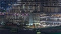 Shopping mall exterior with reastaurants on balconies night timelapse in Dubai, United Arab Emirates