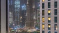 Shopping mall exterior with reastaurants on balconies night timelapse in Dubai, United Arab Emirates