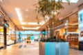 Shopping mall interior blurred background. People shopping in modern commercial mall center. Interior of retail centre Royalty Free Stock Photo