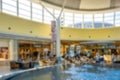 Shopping mall interior blurred background. People shopping in modern commercial mall center. Interior of retail centre store in Royalty Free Stock Photo