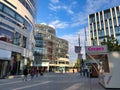 Shopping mall in modern buildings Dusseldorf with autumn fair stall for French Crepes.