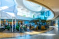 Shopping mall people blurred background. People shopping in modern commercial mall center. Interior of retail centre store in soft Royalty Free Stock Photo