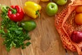 Shopping mesh eco bag with healthy vegan vegetables and fruits on the kitchen at home Royalty Free Stock Photo