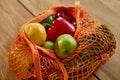 Shopping mesh eco bag with healthy vegan vegetables and fruits on the kitchen at home Royalty Free Stock Photo