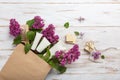 Shopping of natural woman cosmetics with spring lilac bloom.