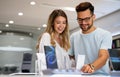 Shopping a new digital device. Happy couple buying a smartphone in store. Royalty Free Stock Photo