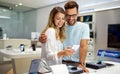 Shopping a new digital device. Happy couple buying a smartphone in store. Royalty Free Stock Photo