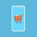 Shopping online concept with smartphone and cart isolated on blue. Royalty Free Stock Photo