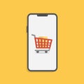 Shopping online concept with smartphone and cart isolated on yellow. Stock Royalty Free Stock Photo