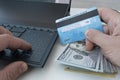 shopping online or transferring money between bank accounts.. Man holding credit card in hand and entering security code using Royalty Free Stock Photo