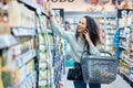 Shopping, phone call and happy woman in a grocery aisle while browsing and choosing products in supermarket, store or Royalty Free Stock Photo