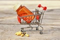 Medical pills and jar in shopping cart Royalty Free Stock Photo