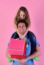 Shopping, presents and family concept. Schoolgirl sits on dads shoulders