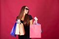 Shopping. Pretty young woman stylishly dressed in black with bags after shopping