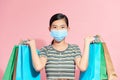Shopping during quarantine conception: fashionable woman wearing protective mask posing with colorful paper bags Royalty Free Stock Photo