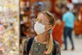 Shopping during quarantine woman wearing protective face mask. Royalty Free Stock Photo
