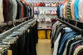 Shelves and racks with trousers, shirts and t-shirts, women underwear. Limited depth of field Royalty Free Stock Photo