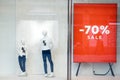 Shopping sale window display with mannequins wearing t-shirts with sign of Sale. Dummies in the store. Sale and fashion Royalty Free Stock Photo