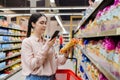 Shopping and sales. Portrait of pretty caucasian woman scan qr code of product using smartphone. Modern consumerism