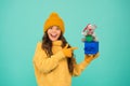 In shopping store. happy new 2020 year. rat symbol of year. small happy girl hold mouse. kid knitted sweater and hat Royalty Free Stock Photo