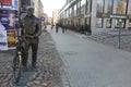 A bronze statue of Stary Marych in the Shopping Street in Poznan, Poland