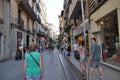 Shopping street with shop windows. People are walking down the street. Royalty Free Stock Photo