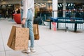 Shopping time, closeup of teenage girl legs with shopping bags at shopping mall. Royalty Free Stock Photo