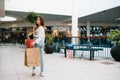 Shopping time, closeup of teenage girl legs with shopping bags at shopping mall. Royalty Free Stock Photo