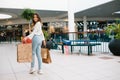 Shopping time, closeup of teenage girl legs with shopping bags at shopping mall. Royalty Free Stock Photo