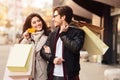 Shopping together. Woman showing credit card to husband Royalty Free Stock Photo