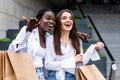 Shopping and tourism concept. Young beautiful girls with shopping bags in ctiy Royalty Free Stock Photo