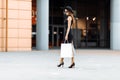 Shopping trip. black Friday. happy attractive girl in an elegant black dress, hat and sunglasses, with shopping bags, as she walks Royalty Free Stock Photo