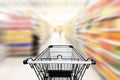 Shopping trolley in department store with consumer goods product