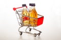 Shopping trolley with filled apple juice bottles Royalty Free Stock Photo