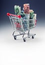 Shopping trolley full of euro money - banknotes - currency. Symbolic example of spending money in shops, or advantageous purchase