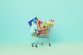 Shopping trolley full of school supplies. Preparation to school, shopping, sale, deals, discounts, promotion