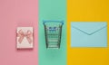 Shopping trolley, gift box, envelope on pastel background. Top view Royalty Free Stock Photo