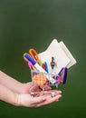 Shopping trolley on the hand near empty green chalkboard Royalty Free Stock Photo