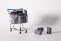 Shopping trolley and tangle of unrolled exposed 35mm film strips Royalty Free Stock Photo