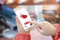 Shopping web site app on smart phone. Woman holding mobile device and buy red shoes Royalty Free Stock Photo