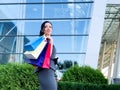 Shopping. Woman holding colored bags near her shooping mall in black friday holiday Royalty Free Stock Photo