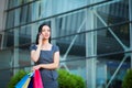 Shopping. Woman holding colored bags near her shooping mall in black friday holiday Royalty Free Stock Photo