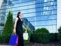 Shopping. Woman holding colored bags near her shooping mall in black friday holiday Royalty Free Stock Photo