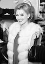 Shopping woman. Woman in white mink fur coat shopping with smiling face Royalty Free Stock Photo