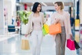 Shopping women talking happy holding shopping bags having fun laughing. Two beautiful young woman girlfriends at mall Royalty Free Stock Photo