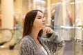 Shopping A young girl looks at shop windows, smiles, makes purchases in a mall Royalty Free Stock Photo